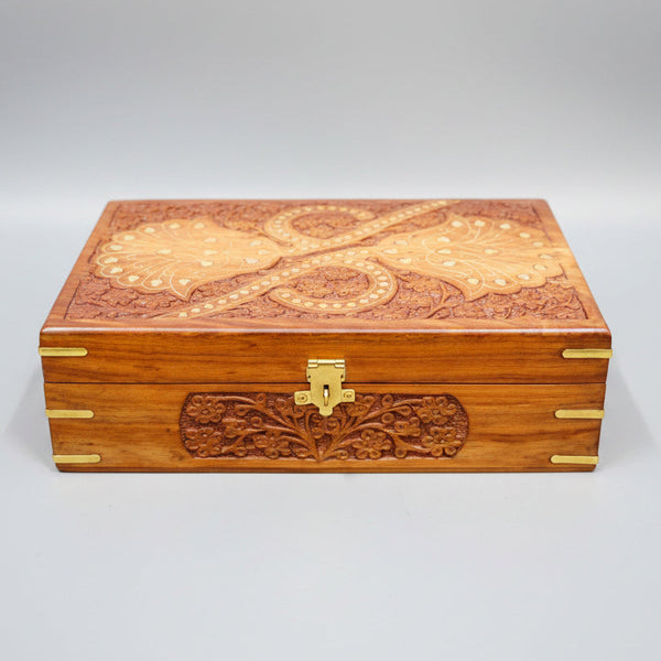Wooden box with floral patterns on a gray surface