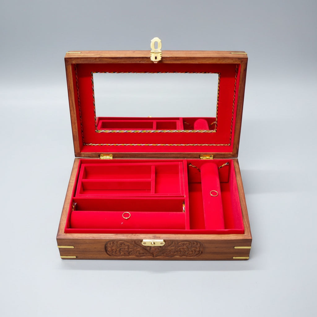 Open jewelry box with red interior and wooden exterior on a dark surface